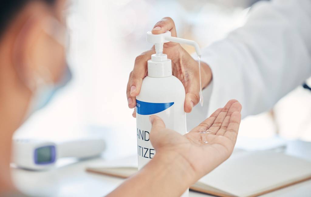 Hand Sanitizer being applied to a human hand. How over sanitization has an environmental cost to users. DERMAGLOVE products alleviates the dependency on alcohol based products.